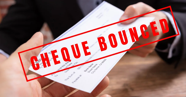 Cheque bounce legal notice and financial documents on desk